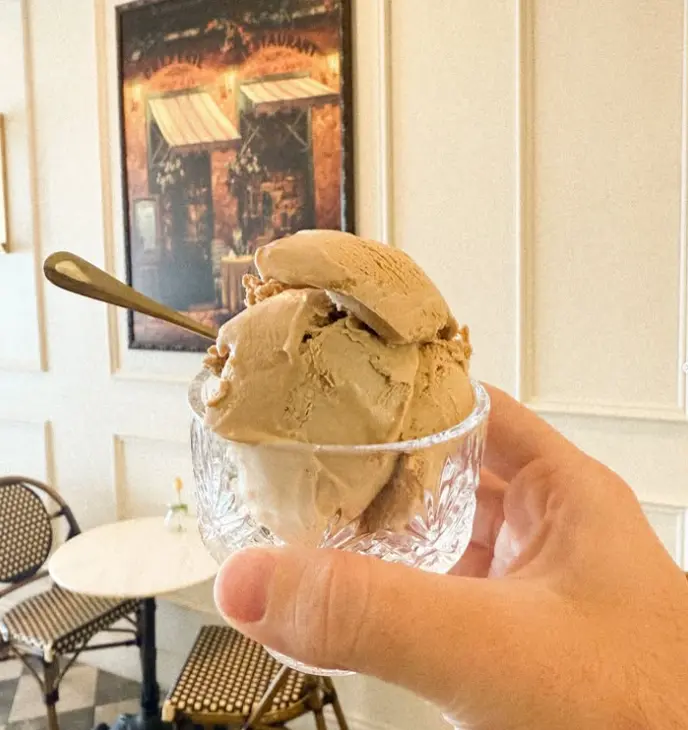 A scoop of gelato served in a glass dessert cup